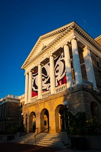 Bascom Hall, featuring Bucky Badger banners, is pictured during sunrise at the University of Wisconsin-Madison on August 30, 2021. (Photo by Bryce Richter / UW-Madison)