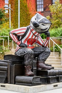"Well Red," a sculpture by artist Douwe Blumberg of a studious-looking UW-Madison mascot Bucky Badger sitting atop a pile of books, is pictured at Alumni Park at the University of Wisconsin-Madison during autumn on Oct. 30, 2021. (Photo by Jeff Miller / UW–Madison)