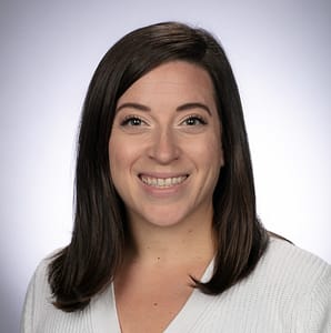 Image of Caitlin Luetger-Schlewitt. A smiling woman with shoulder-length brown hair.